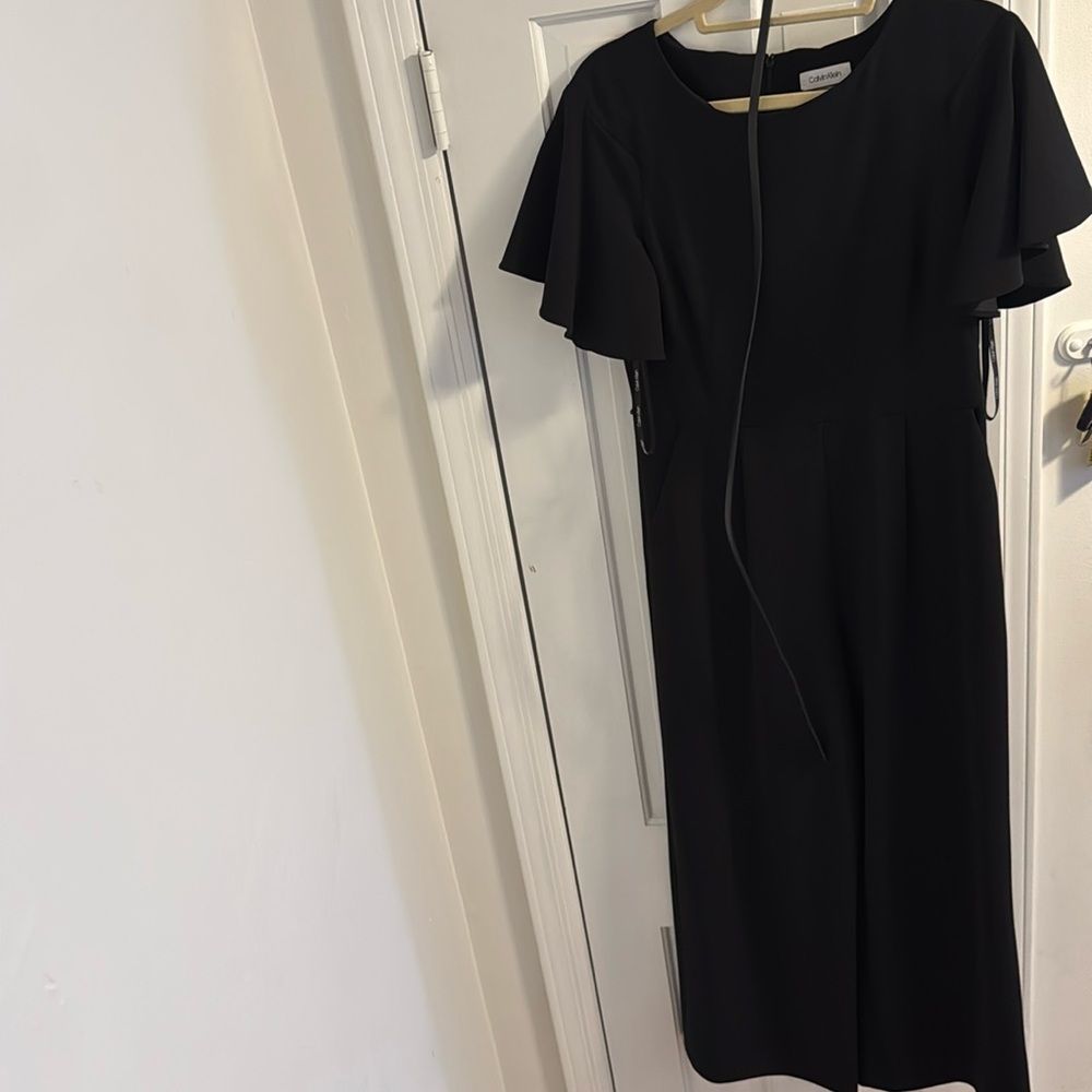 Black Calvin Klein jumpsuit with thin belt, short flowy sleeves